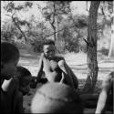 Boy playing /Ui (the counting game) with a group of boys