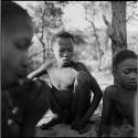 Boy playing /Ui (the counting game) with a group of boys