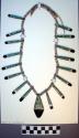 Santo Domingo necklace. 1 strand of shell beads w/ long inlay pendants intersper