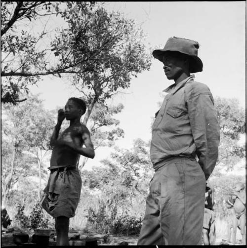 Bojo wearing Western clothing, standing with /Gunda