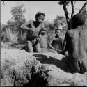 Boys playing !ó'm!hú / !’Om g!xuni / ’Ai kota !U!u g!xuni / N!aih //’an (the porcupine game, also known as the axe game, assegai game or war game)