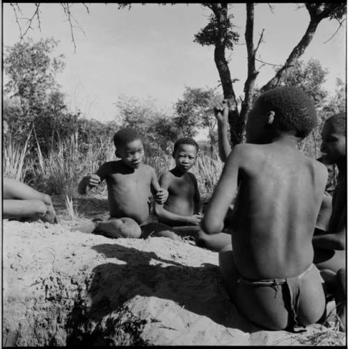 Boys playing !ó'm!hú / !’Om g!xuni / ’Ai kota !U!u g!xuni / N!aih //’an (the porcupine game, also known as the axe game, assegai game or war game)