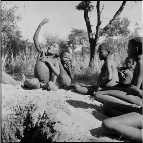 Boys playing !ó'm!hú / !’Om g!xuni / ’Ai kota !U!u g!xuni / N!aih //’an (the porcupine game, also known as the axe game, assegai game or war game)