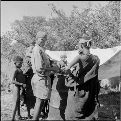 Group of children standing next to the expedition rain-saver barrel