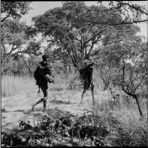 Two men walking to the veld to hunt