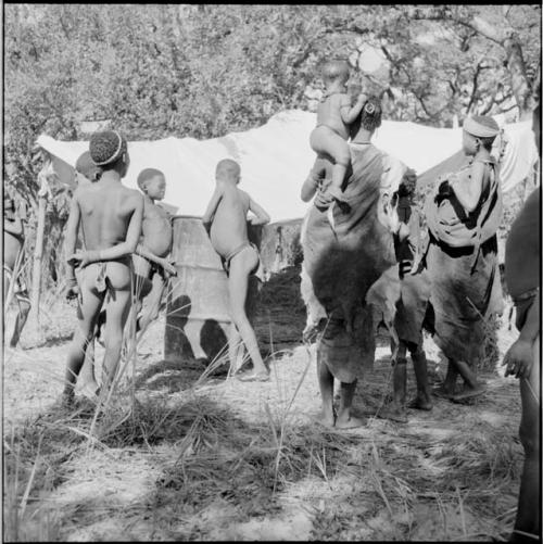 Group of women and children standing next to the expedition rain-saver