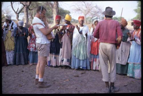 Nicholas England records Herero women singing while the man on the left performs a "cattle dance"
