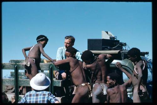 Expedition, Sound Recording: Group of people standing on an expedition truck, with Hans Ernst sitting next to sound recording equipment