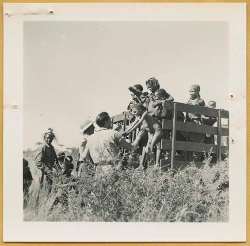 Women and children being helped down from the expedition truck by Heinrich Neumann and Ernst Westphal