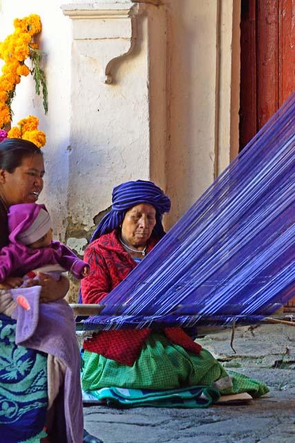 "Vendor: a woman weaving with back strap loom"