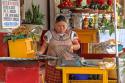 "Vendor: a woman makes blue corn tortillas near wher launches (water taxs) dock"