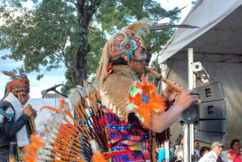 "Plaza Grande; Inka Azteka, Ecuador, (performer with animal skin, orange feathers)"