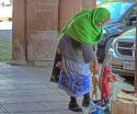 "Vendor: a woman setting up items for sale at Plaza Grande"