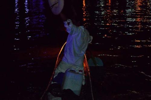 "Butterfly net fisherman paddle around the lake on the Night of the dead"