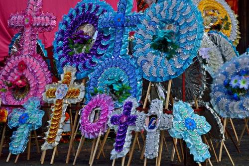 "Plastic altar offerings are available as well as the more traditional flower displays"