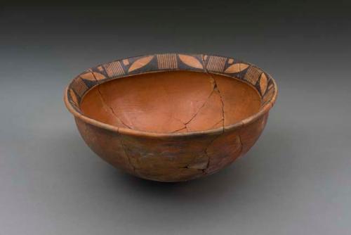 Large restored red pottery bowl, rim decorated in black