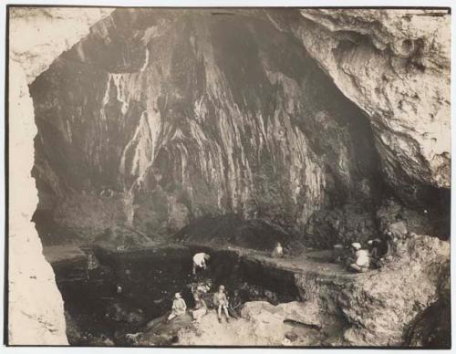 People sitting and working at El Zuttiyeh cave