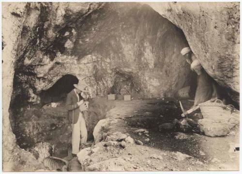 Man in Western dress working at Emireh  cave