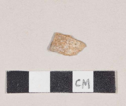 Coarse buff bodied earthenware body sherd, missing finished surfaces