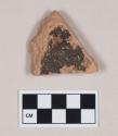 Coarse red bodied earthenware body sherd, with buff slip and blackened interior