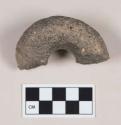 Ground stone object fragment, possible handle or fragment of stone ring