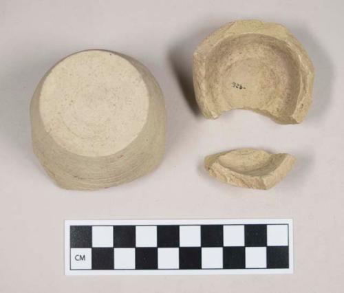 Green bodied earthenware base sherds, unslipped, wheel thrown; two sherds crossmend