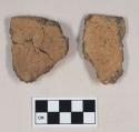 Coarse brown bodied earthenware rim sherds, reduced core; one is made up of several sherds, crossmended with glue, with mounting pin nailed and glued to it