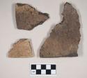 Coarse gray bodied earthenware rim sherds, undecorated; coarse brown bodied earthenware rim sherd, undecorated