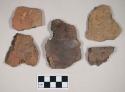 Coarse red bodied earthenware body sherd, reduced core, made of two sherds crossmended with glue; coarse brown bodied earthenware body sherds; coarse red bodied earthenware rim sherd, reduced core; coarse gray bodied earthenware rim sherd