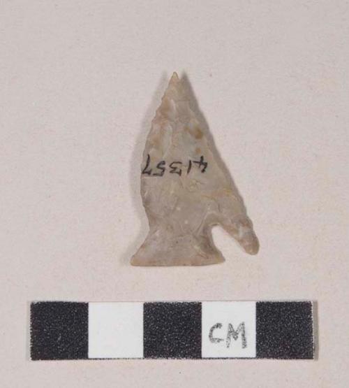 Chipped stone, projectile point, asymmetrical, one side is corner-notched, one side is side-notched