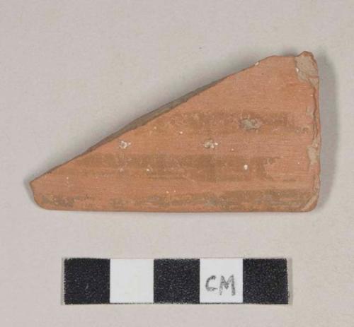 Red bodied earthenware rim sherd, unslipped, with red slipped stripes, reduced core