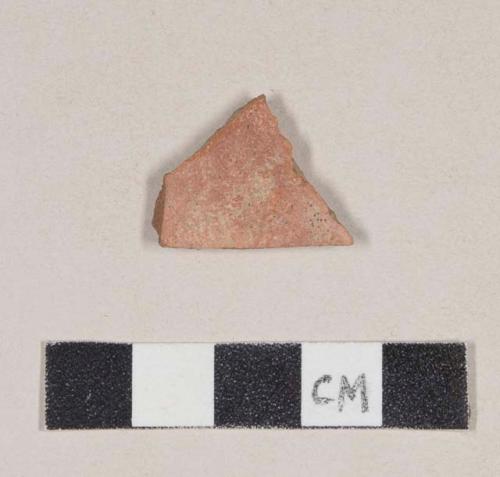 Red bodied earthenware body sherd, with red slipped exterior and buff slipped interior