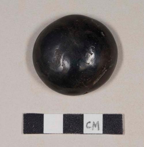 Ground stone, hemispherical disk, hematite