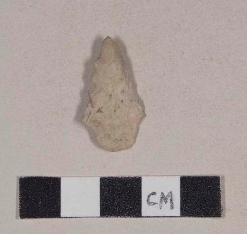 Chipped stone, projectile point, stemmed, serrated