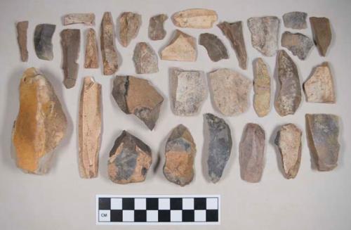 Chipped stone, flint blades, some with cortex, some with retouching or use wear; chipped stone, flint cores, with cortex; chipped stone, flint flakes, one with cortex, one with retouching or use wear