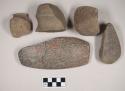 Ground stone axe fragments, some grooved; ground stone adze fragment