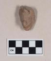 Red bodied earthenware figurine head fragment, with some red pigment