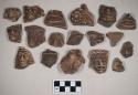 Red bodied earthenware figurine sherds, most human in appearance, some with handles, some with red pigment