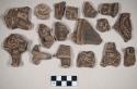 Red bodied earthenware figurine sherds, most human in appearance, some with handles, some with red pigment