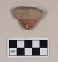 Red bodied earthenware figurine sherd, human in appearance, with red pigment