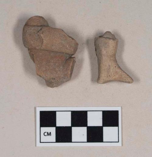 Red bodied earthenware figurine sherds, one human in appearance, one with red pigment
