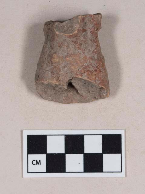 Red bodied earthenware figurine sherd, with red pigment