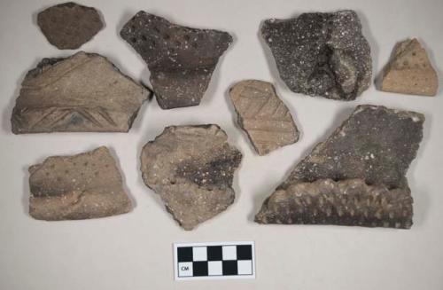 Coarse earthenware body and rim sherds, incised, punctate, rocker dentate, shell temper