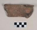 Coarse earthenware rim sherd, cord impressed, incised rim and lugs, shell temper