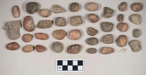 Pebbles and stone fragments; stemmed biface fragment