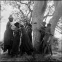 ≠Gisa playing Tcxai Djxani (a dancing game) with a group of girls at a tree