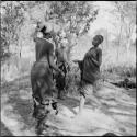 Group of women and girls playing khù n≠haru (skip-rope), with ≠Nisa and N!ai holding the rope