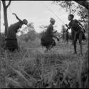 Group of women and girls playing khù n≠haru (skip-rope), with ≠Nisa skipping