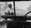 Man sitting on the front of the expedition Jeep, pointing, guiding the group to a hunting area