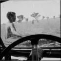 Man sitting on the front of the expedition Jeep, pointing, guiding the group to a hunting area